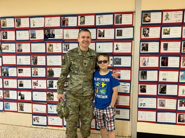 Veteran with student in hallway